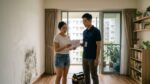A mold remediation technician reviewing a quote with a homeowner in Singapore